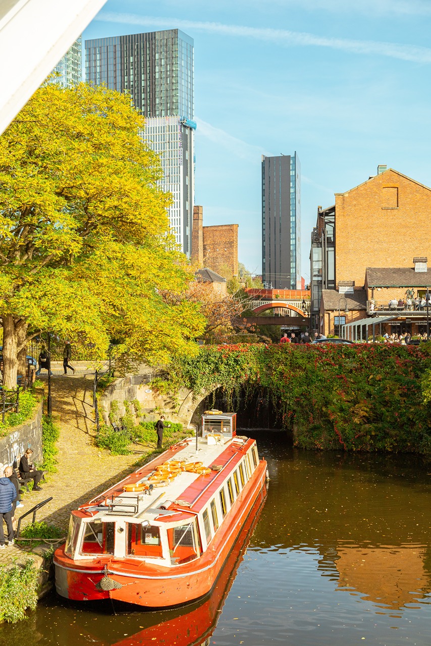 Seasonal allure vibrant autumn scene of a canal with vintage boat