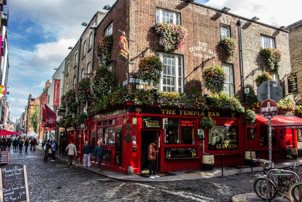 Iconic red exterior storefront of the historic Temple Bar pub in Dublin, Ireland.