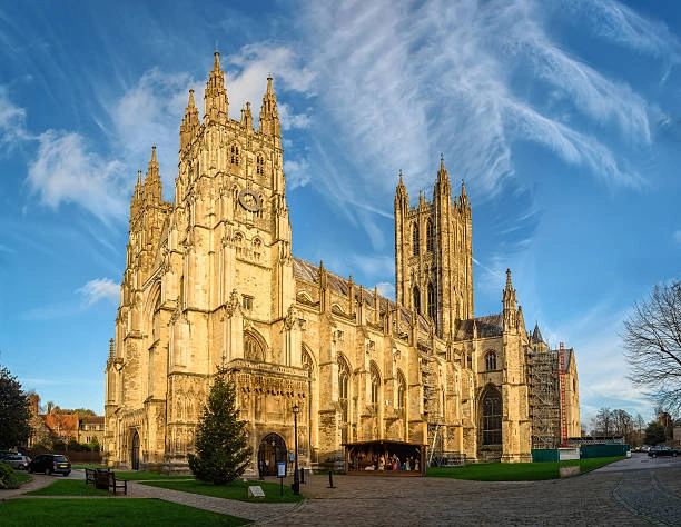 Canterbury Cathedral illuminated in warm sunlight with intricate Gothic façade
