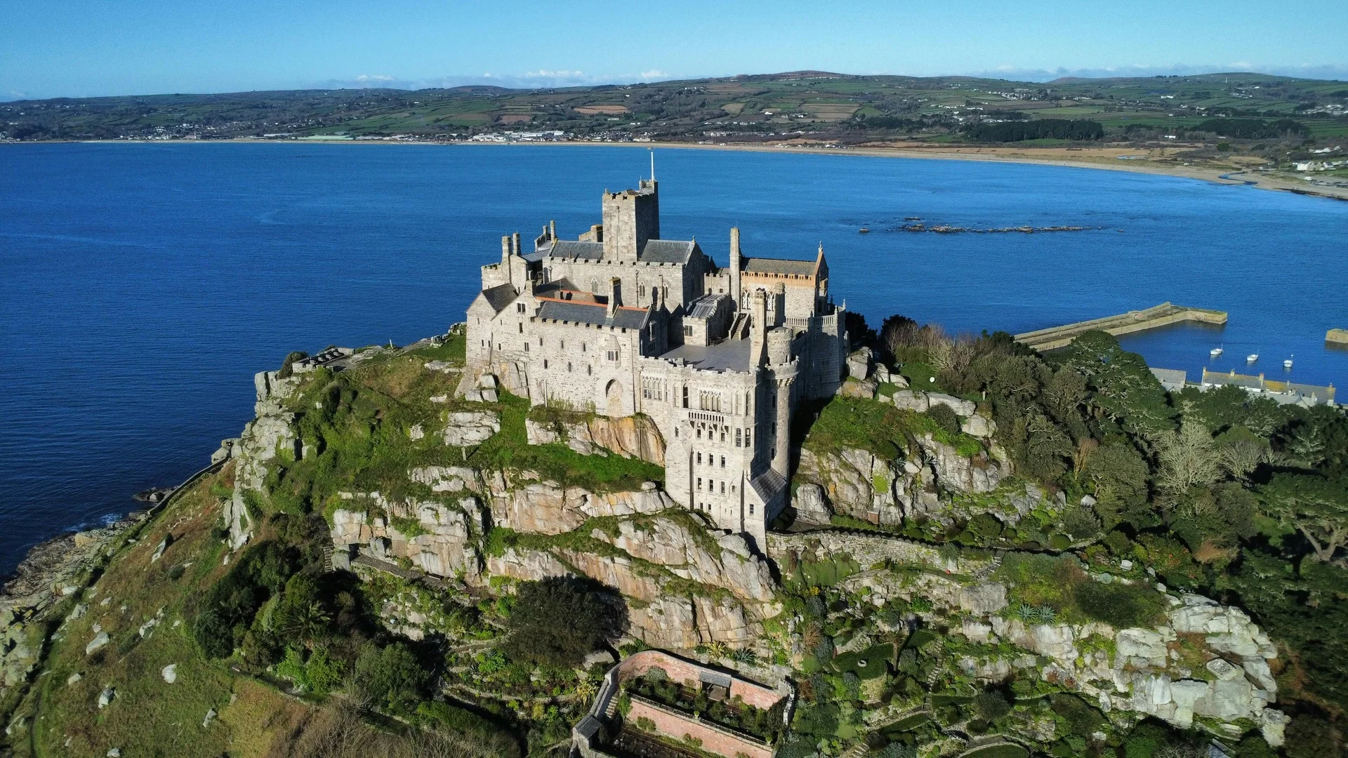 Aerial view of St. Michael’s Mount, a historic castle surrounded by the sea in Cornwall, UK.