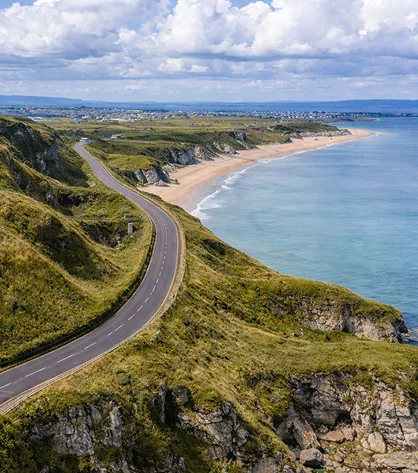 Panoramic view of Northern Ireland’s rolling hills, rugged coastlines, and wide-open skies.