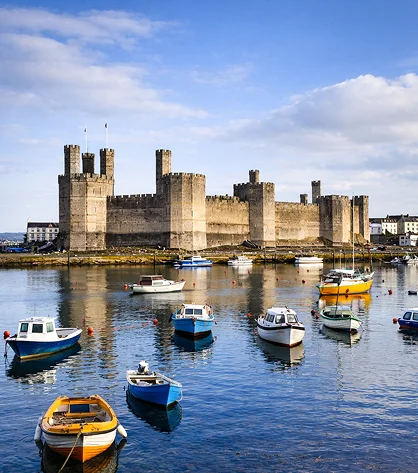 Detailed view of Wales’ beauty with valleys, mountains, and lush landscapes under clear skies.