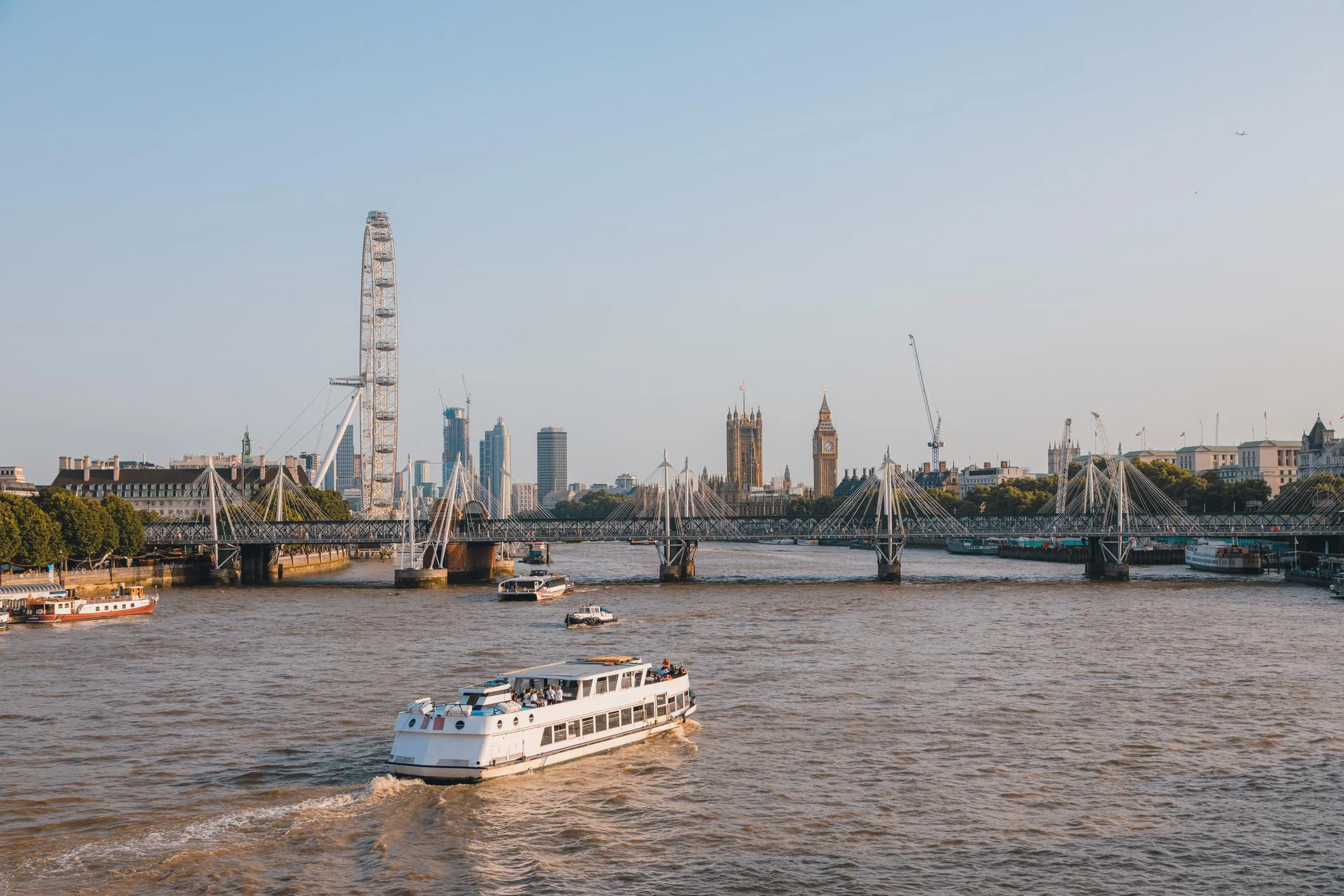 Group of tourists on a scenic river cruise boat tour exploring UK waterways