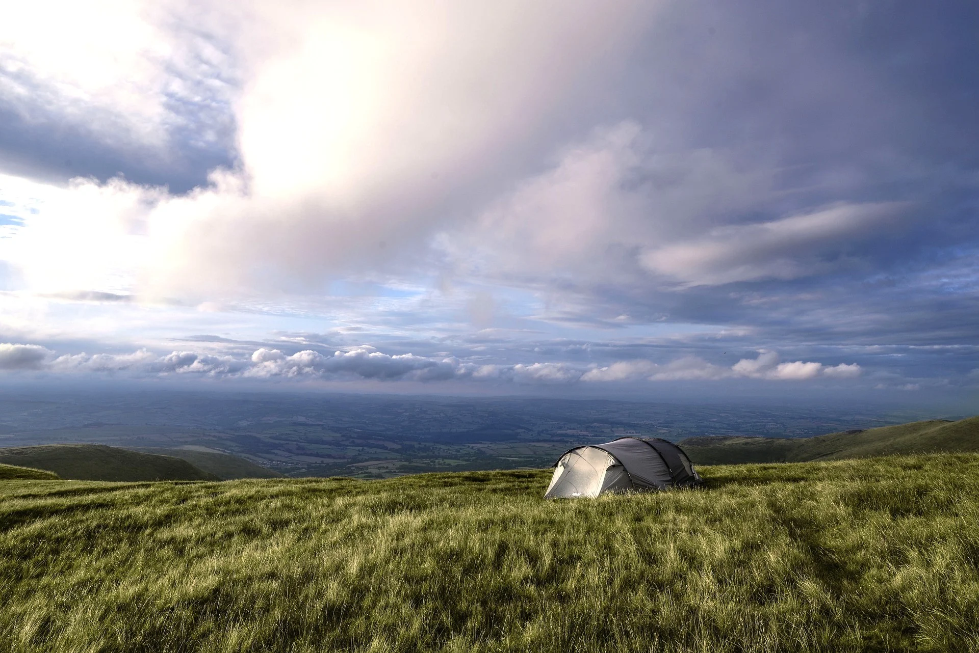 Interior of the Long Room at Trinity College Dublin, showcasing two levels of dark oak bookshelves and a barrel-vaulted ceiling.