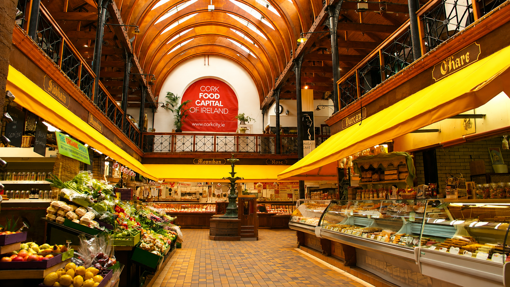 Historic indoor food market in Cork with artisan food stalls beneath a vaulted wooden ceiling
