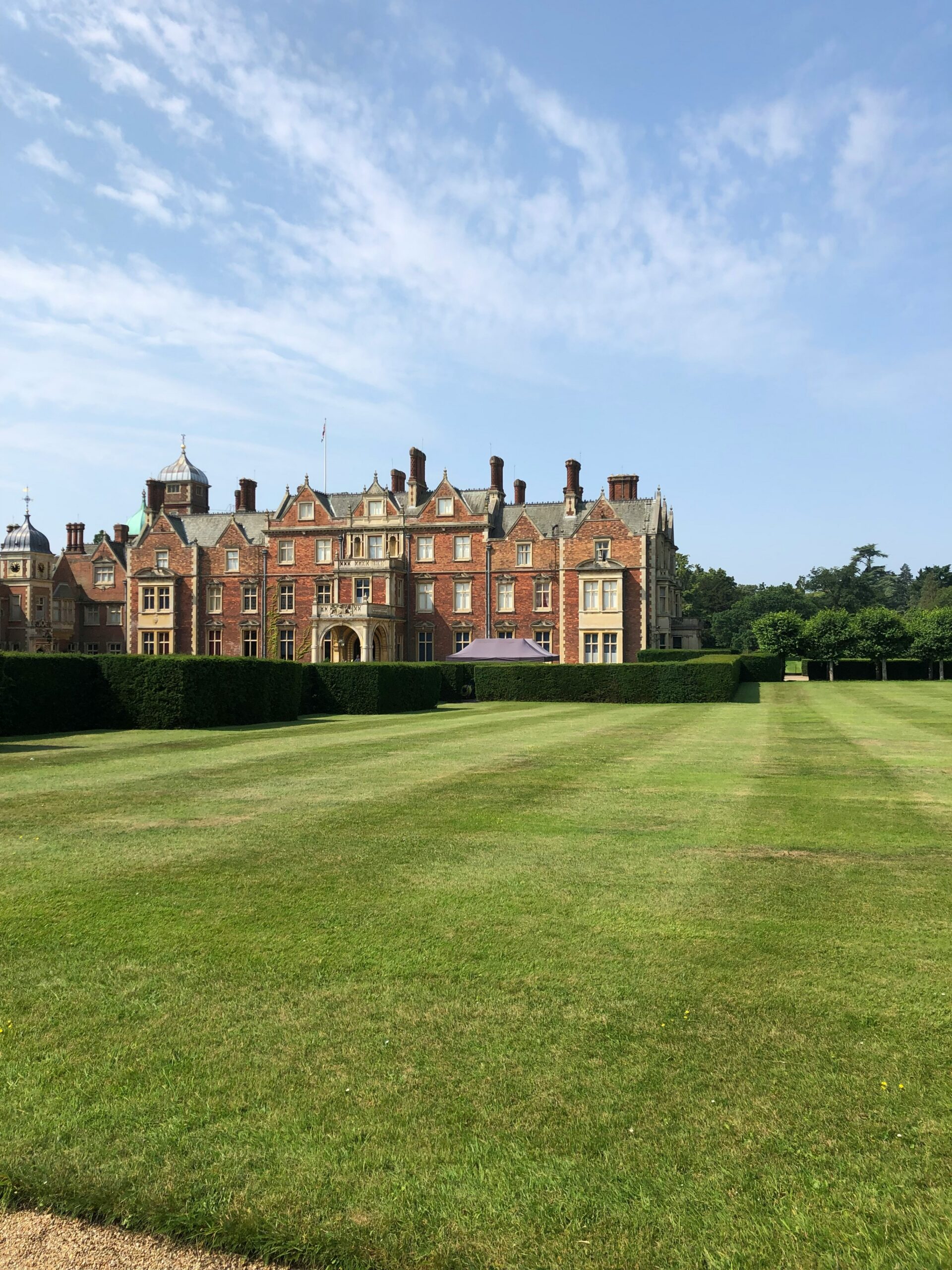 Sandringham House red brick royal residence overlooking manicured estate lawns