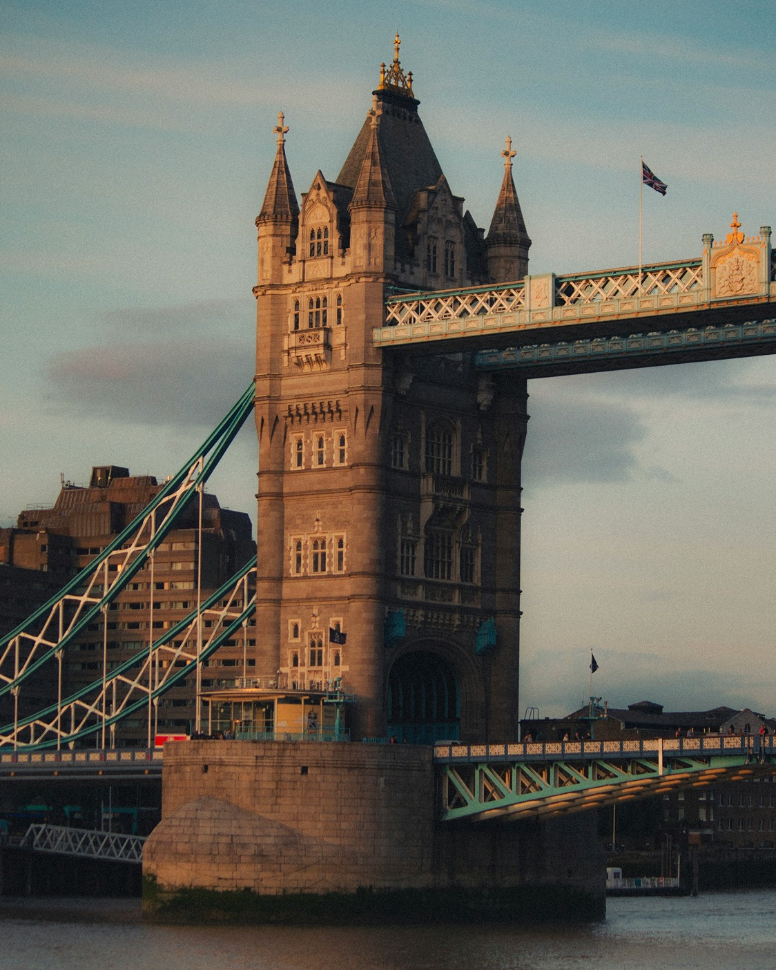 Tower Bridge illuminated at dusk, viewed from near the Tower of London