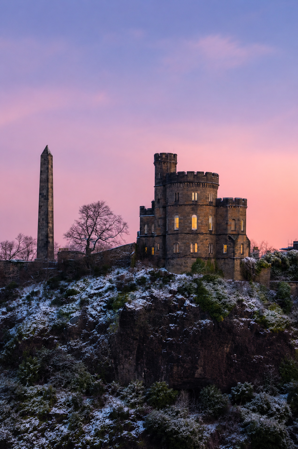 Snow-dusted monument on Calton Hill overlooking Edinburgh at winter sunset